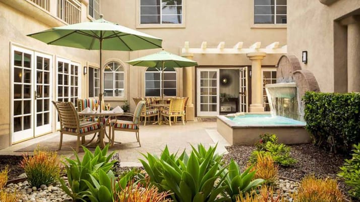 Outdoor seating area with umbrellas and fountain