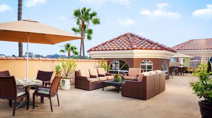 Outdoor lounge area with comfortable seating and umbrellas