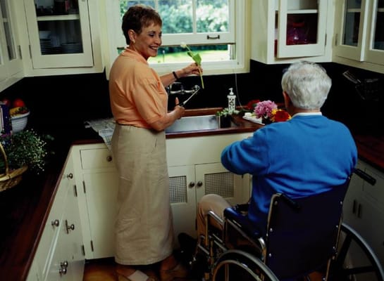A caregiver assisting a resident in the kitchen