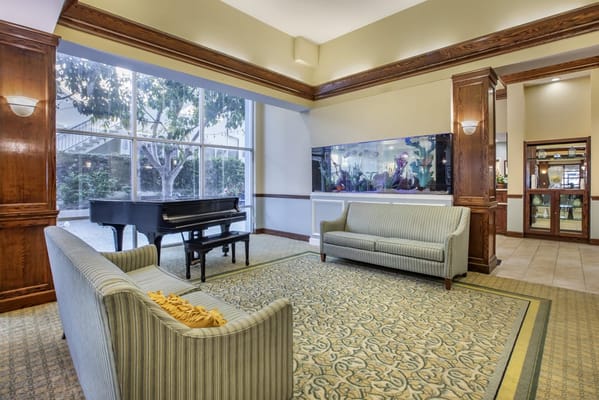 Bright, inviting lounge area with a piano
