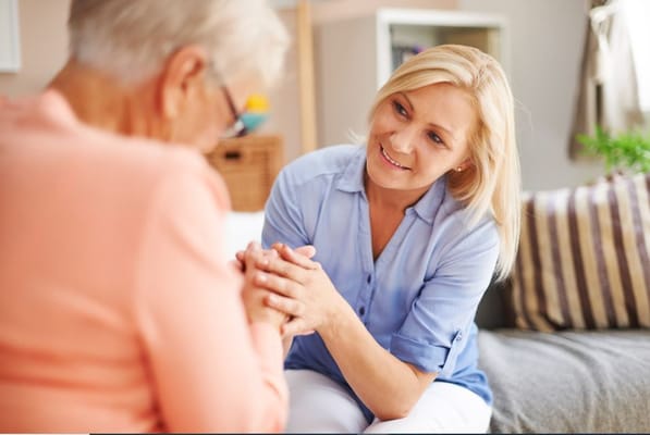 Caregiver interacting with a resident in a cozy setting