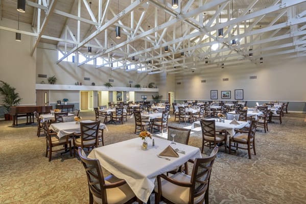 Bright and spacious dining room with tables set for meals