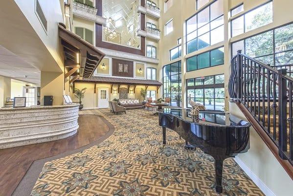 Interior view of the facility lobby with piano and seating