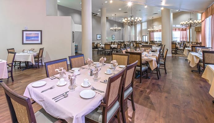 Dining area with neatly set tables and chairs