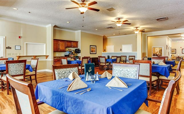 Dining room with blue table settings and no people