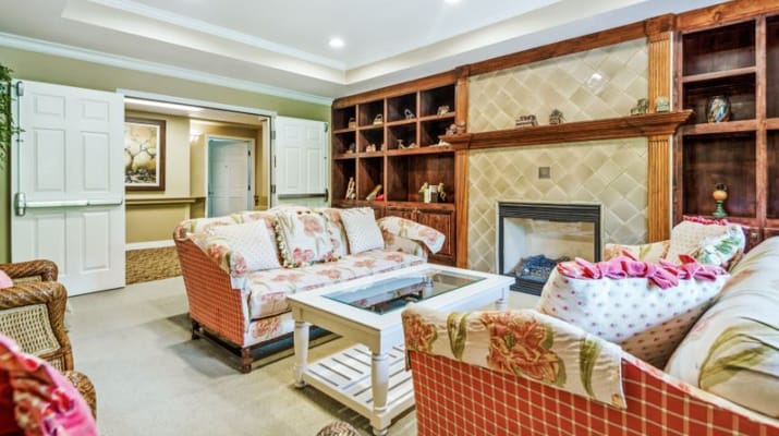 Cozy common area with floral sofas and fireplace