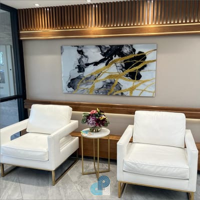Bright lobby area with modern white chairs and artwork