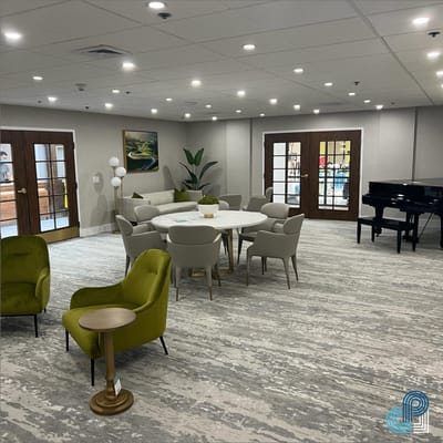 Bright common area with seating and a piano