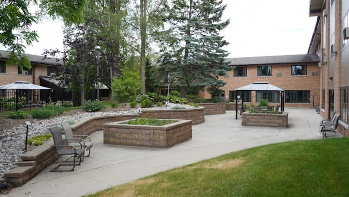 Garden area with seating and pathways at Pine Haven