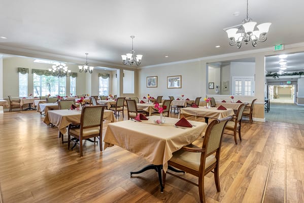 Bright dining room with tables set for a meal