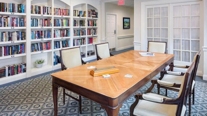 Cozy common area with bookshelves and a large table