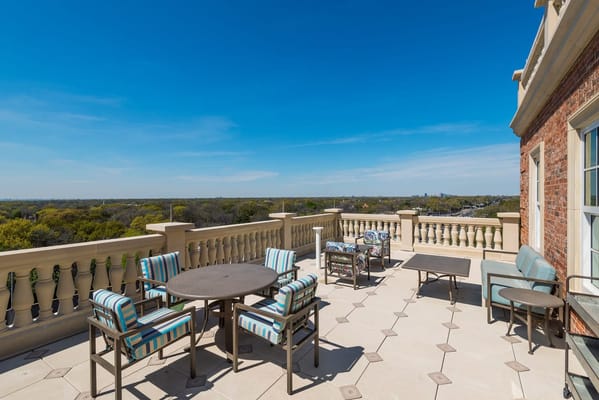 Rooftop terrace with seating overlooking a green landscape