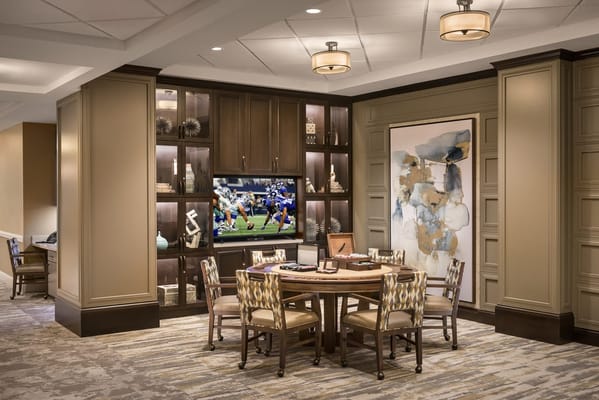 Relaxing living room area with a TV and decorative shelves