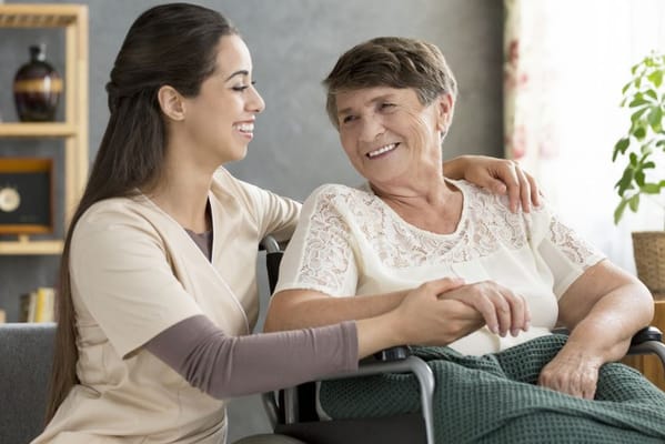 Caregiver smiling with a resident in a cozy living space