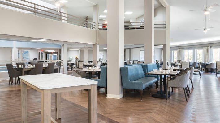 Dining area with tables and chairs in a bright setting