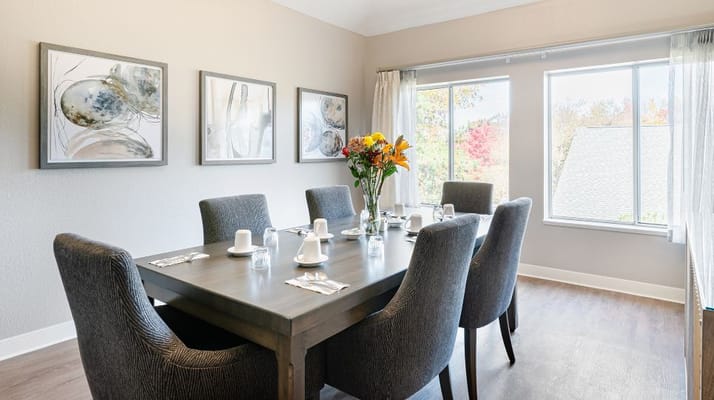 Bright dining room with a table set for meals