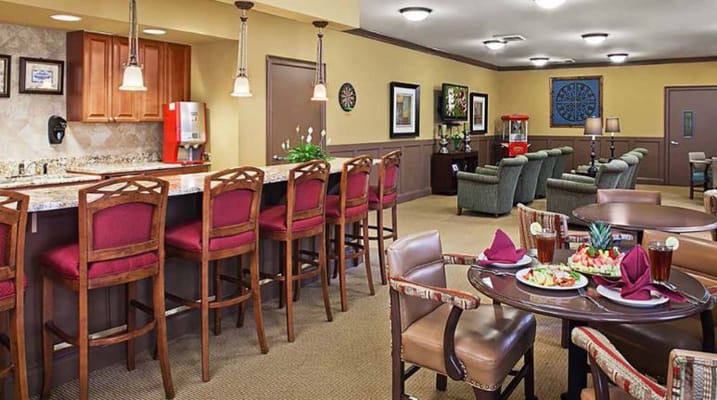 Bright common area with seating and food displayed.