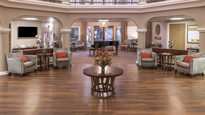 Bright and spacious lobby with seating and a piano