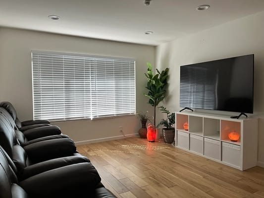 Living room with comfortable seating and a large TV