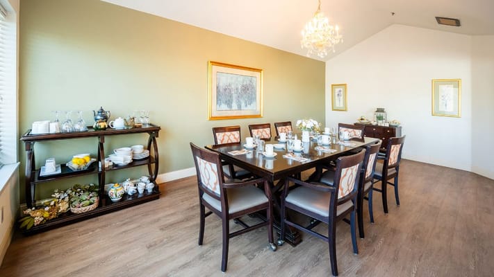 Bright dining room with a large table set for a meal