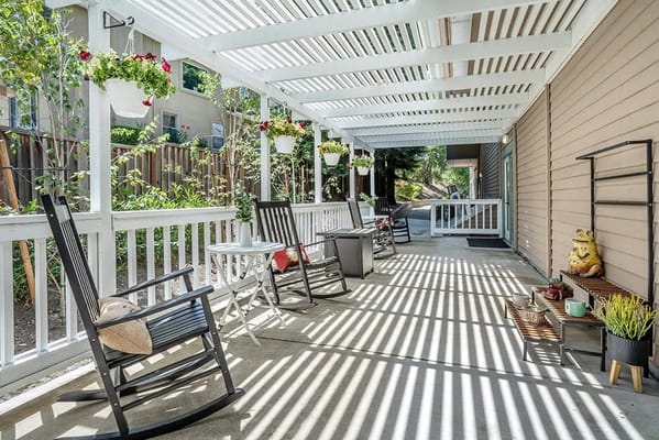 Covered outdoor patio with seating and plants