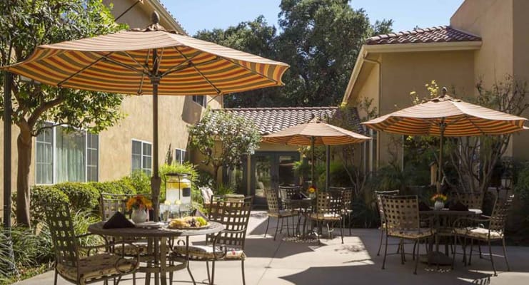 Outdoor patio area with umbrellas and seating