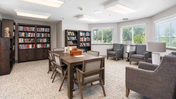 Inviting library space with bookshelves and seating at Sierra Hills