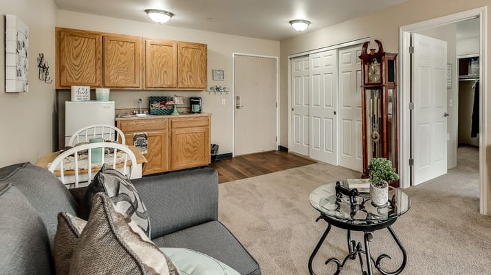 Interior view of a studio apartment with kitchenette and living area.
