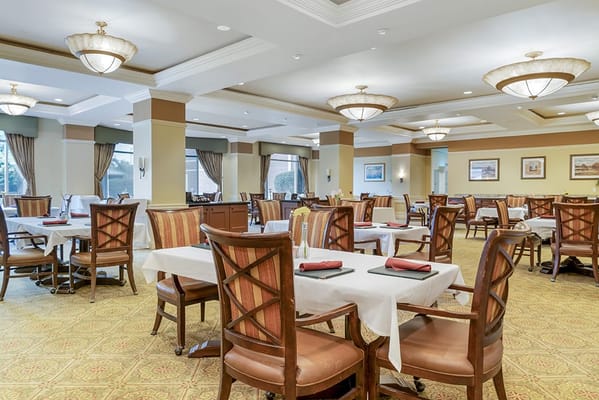 Dining room with tables and chairs prepared for a meal