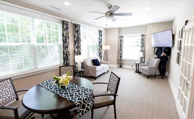 Bright living room with seating and decorative table in Story Cottage.