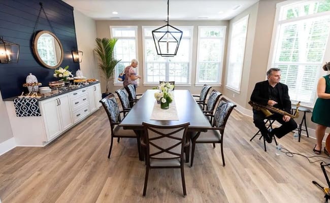Dining area set up for an event with a long table and refreshments