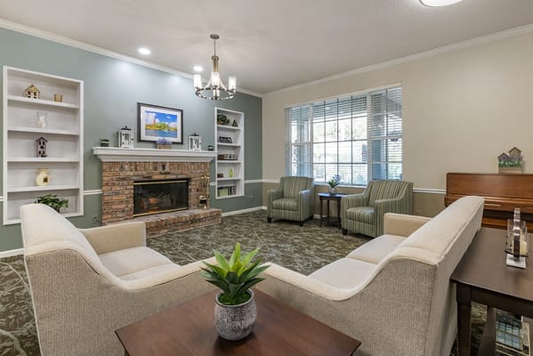 Bright common area with seating and fireplace