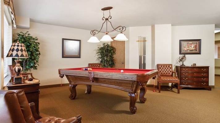 Billiards room with a pool table and seating