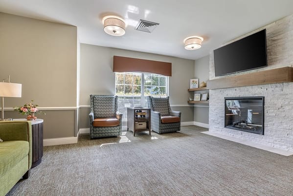 Bright common area with comfortable seating and fireplace