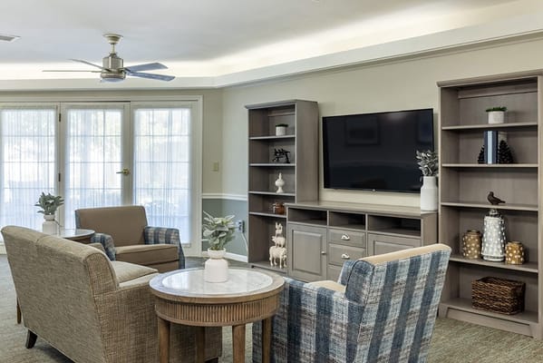 Bright common area with comfortable seating and TV