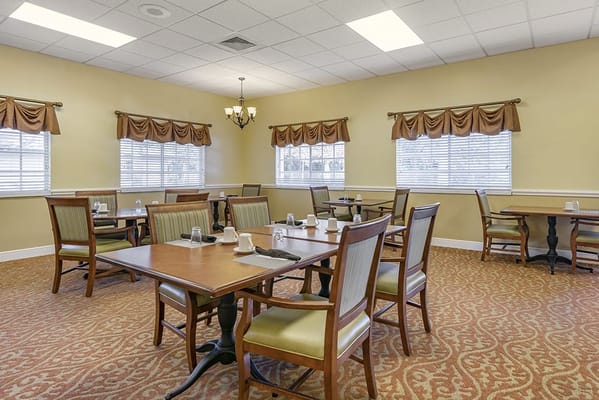 Bright dining room with multiple tables and chairs