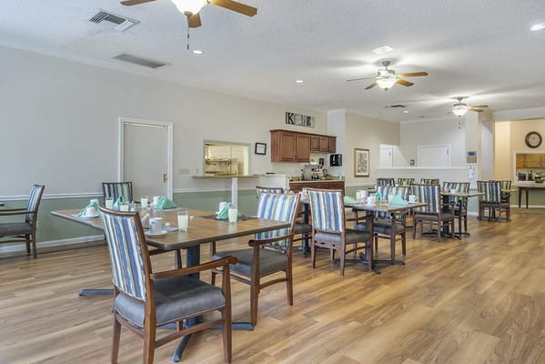 Dining area set for a meal with tables and chairs