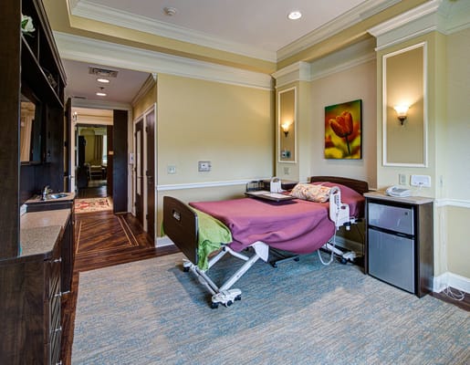 Comfortable patient room with a bed, desk, and amenities
