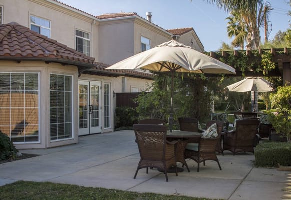 Outdoor patio area with seating and umbrellas