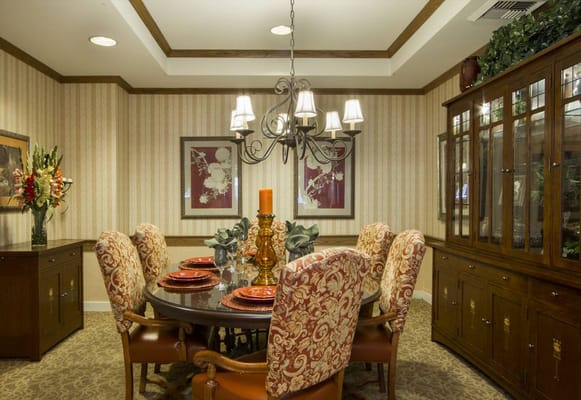 Elegant dining room with a chandelier and decorated table