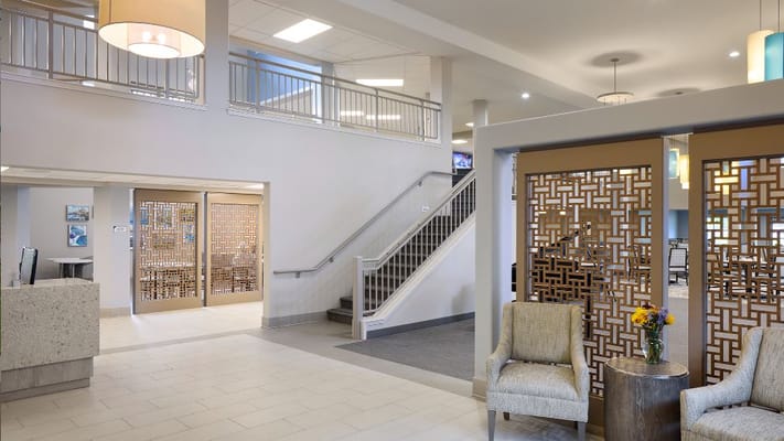 Spacious lobby area with chairs and decorative lighting