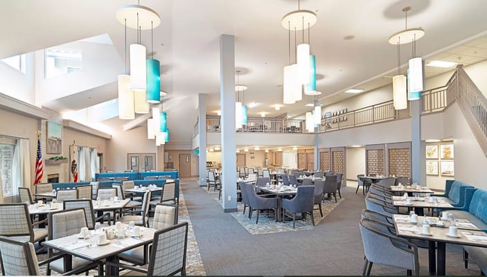 Bright and spacious dining room with tables set for meals