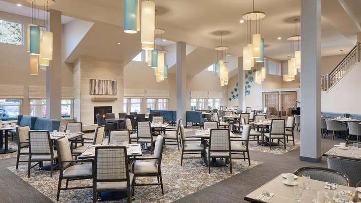 Bright and modern dining area with tables and chairs