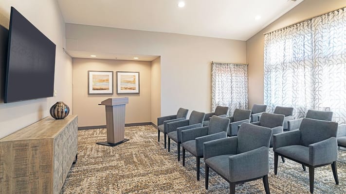 Bright activity room with seating and a podium