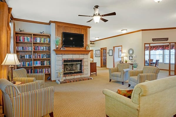 Bright common area with comfortable seating and bookshelves