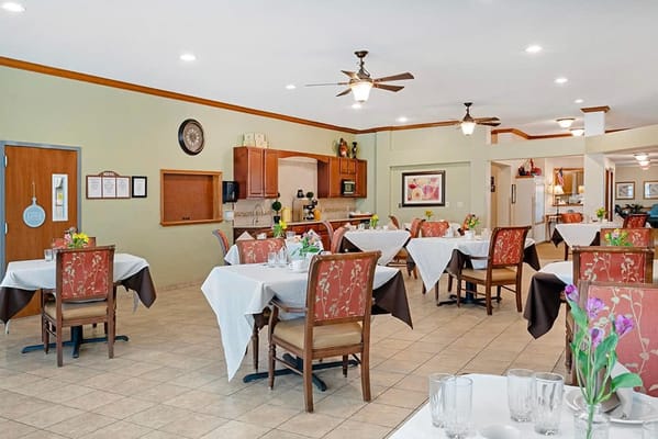 Dining area with tables and flowers in a bright room