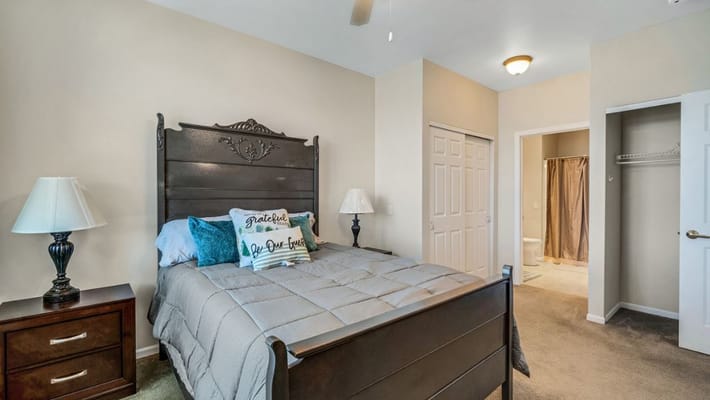 A well-furnished resident room with a bed and decor
