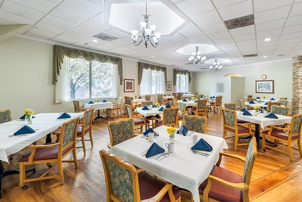 Bright dining room with tables set for a meal