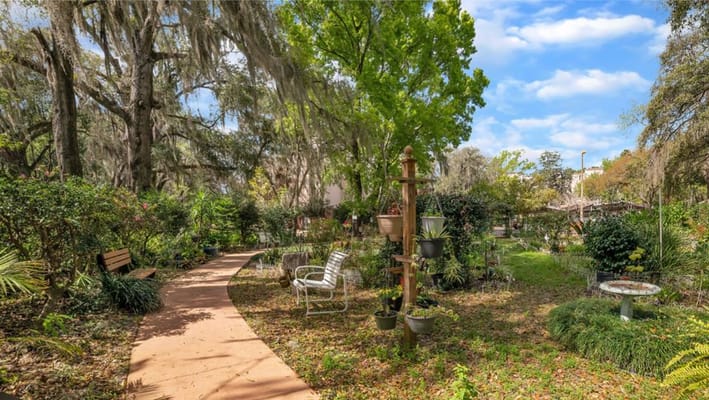 A serene garden area with walking path and seating