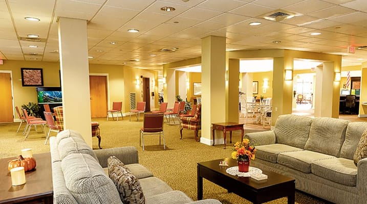 Bright common area with comfortable seating and tables